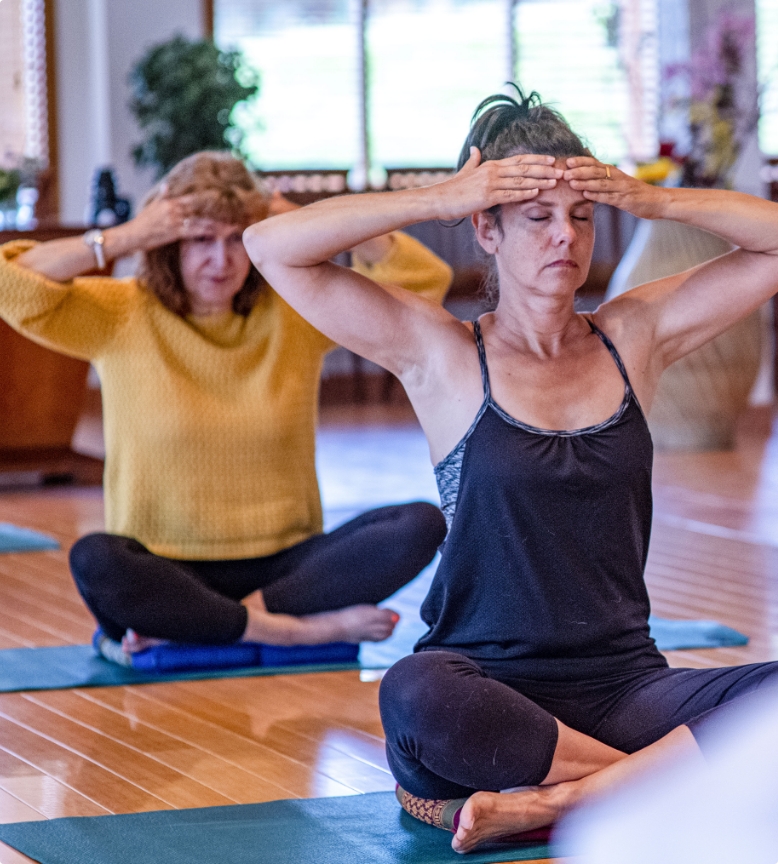 Two women practicing mindful yoga