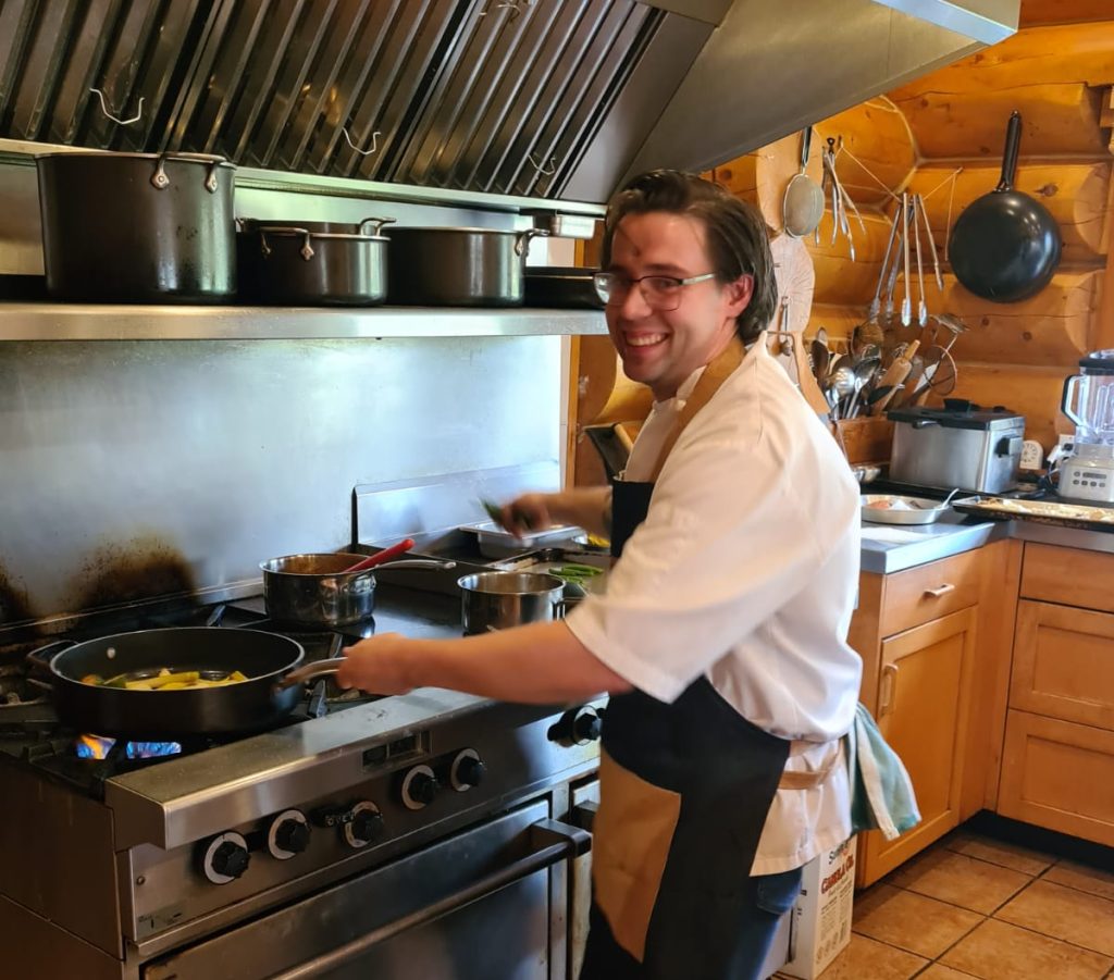 Chef Lucas Istace preparing dinner on stove